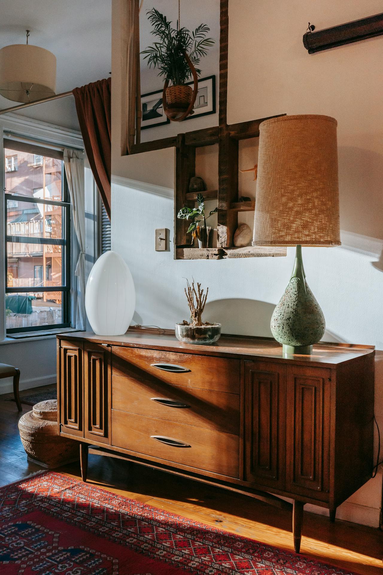 A retro wooden cabinet with ornaments on top of it.