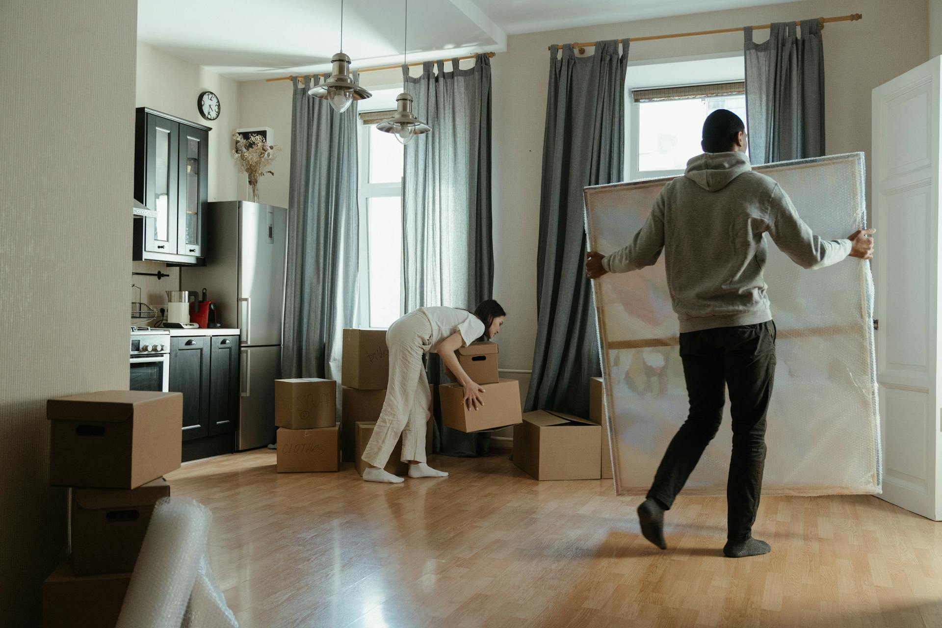 A couple moving into their new home and unboxing their belongings.