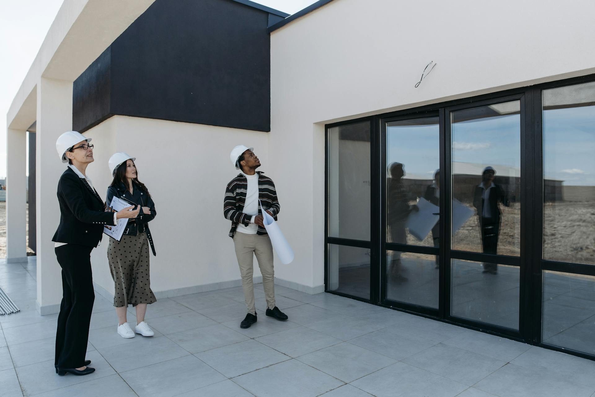 A couple viewing a new build property, looking at garden doors of the property.
