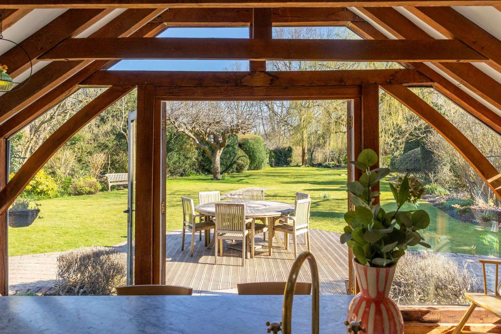 View from kitchen with wooden beams out on to garden