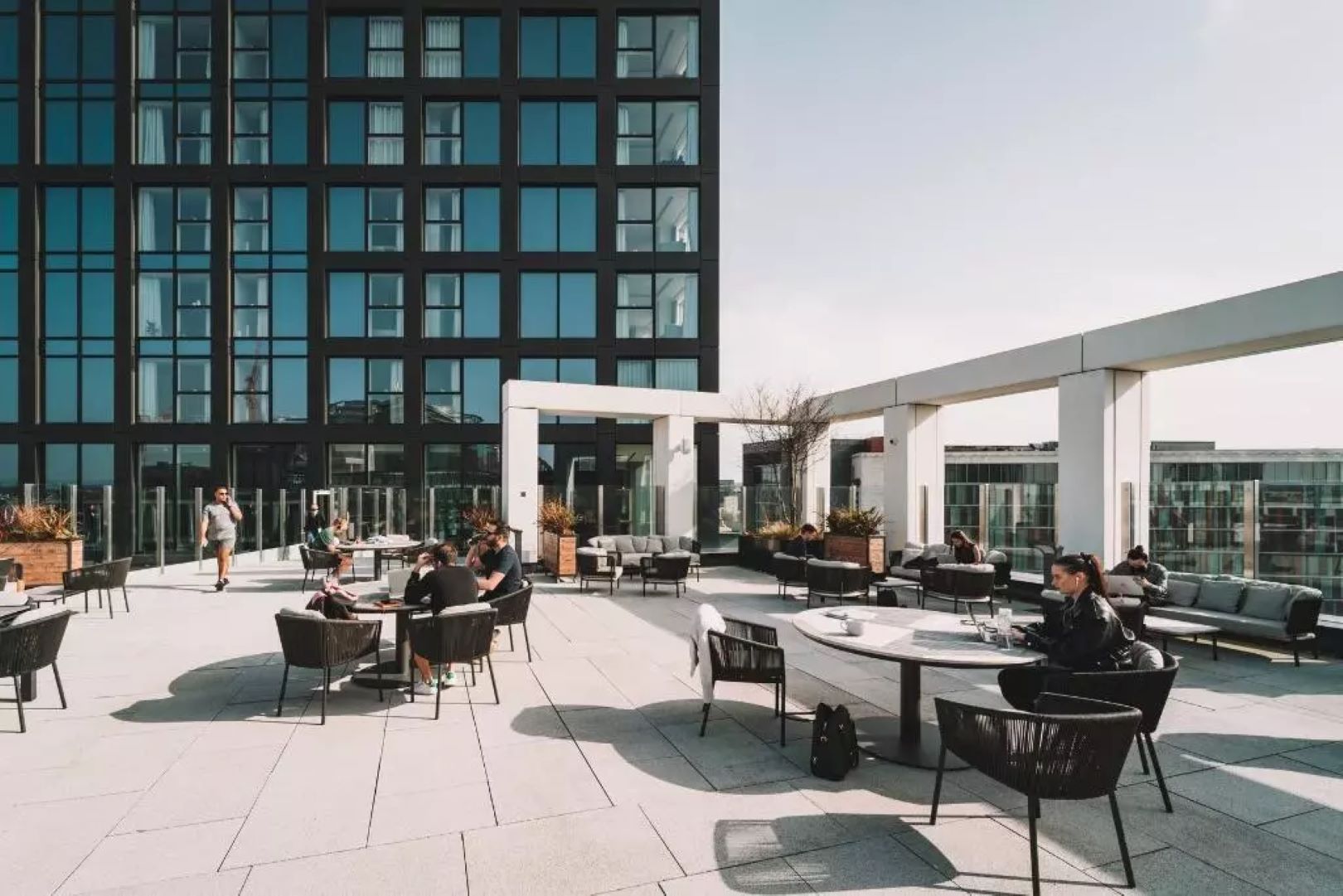 Rooftop terrace with seating and building in the background