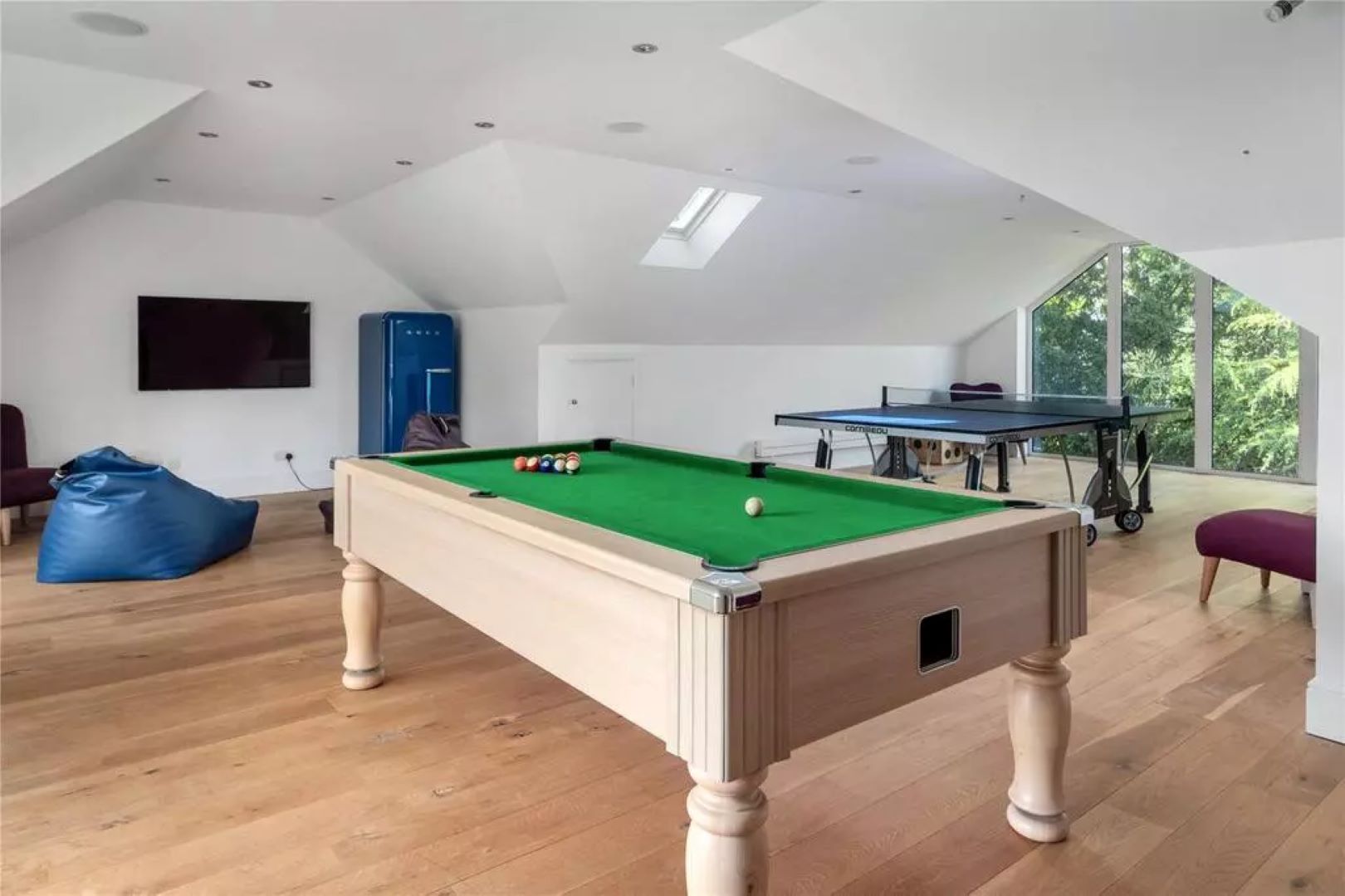Games rooms with pool table, ping pong table, bean bags and a TV