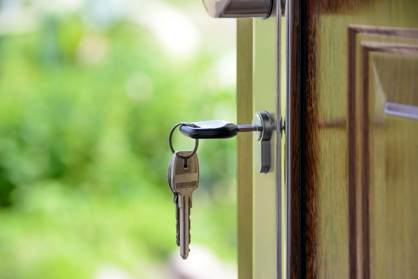 A key in a lock on an open door