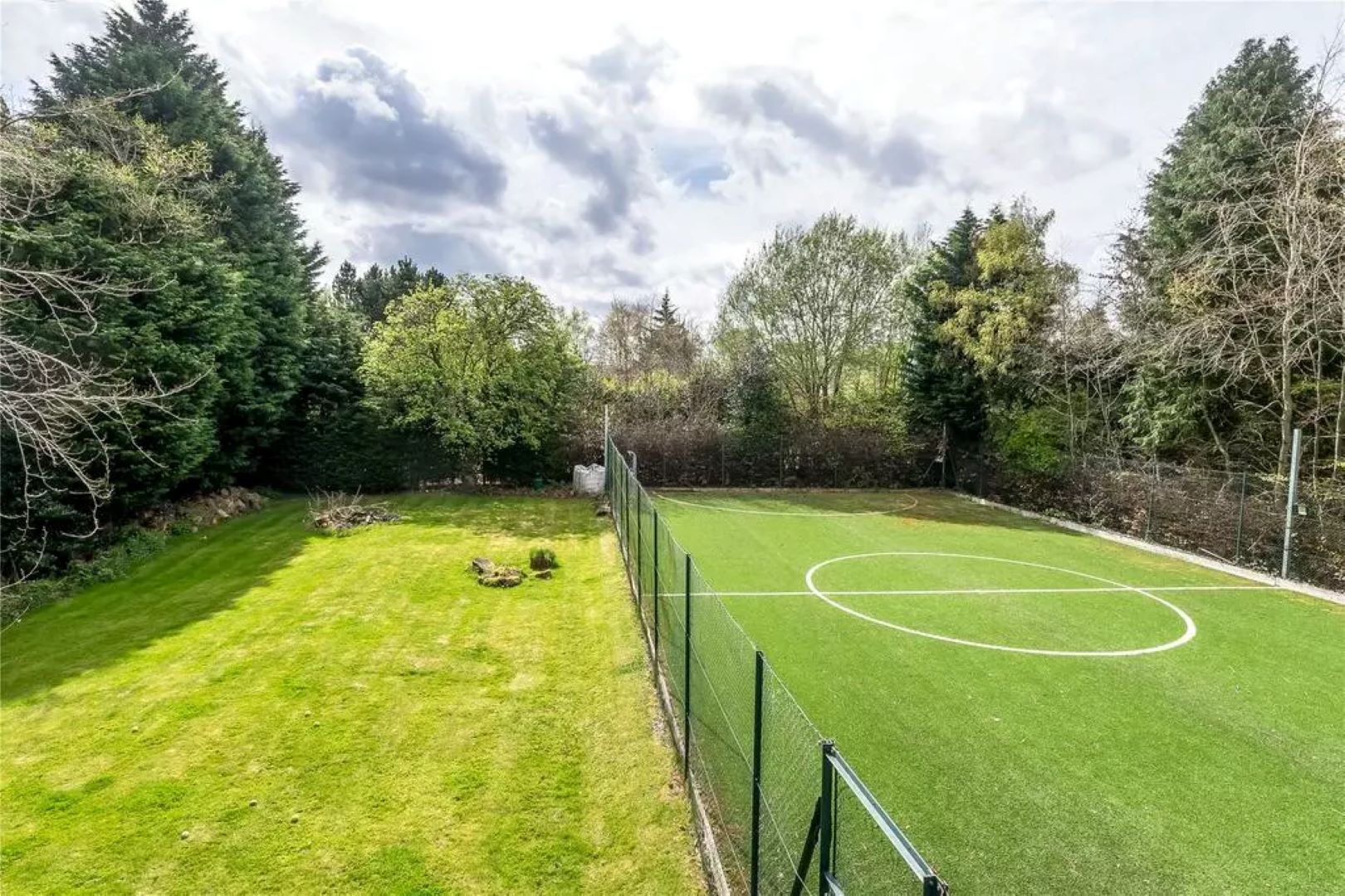 Garden split in half with lawn on the left hand side and a mini football pitch on the right