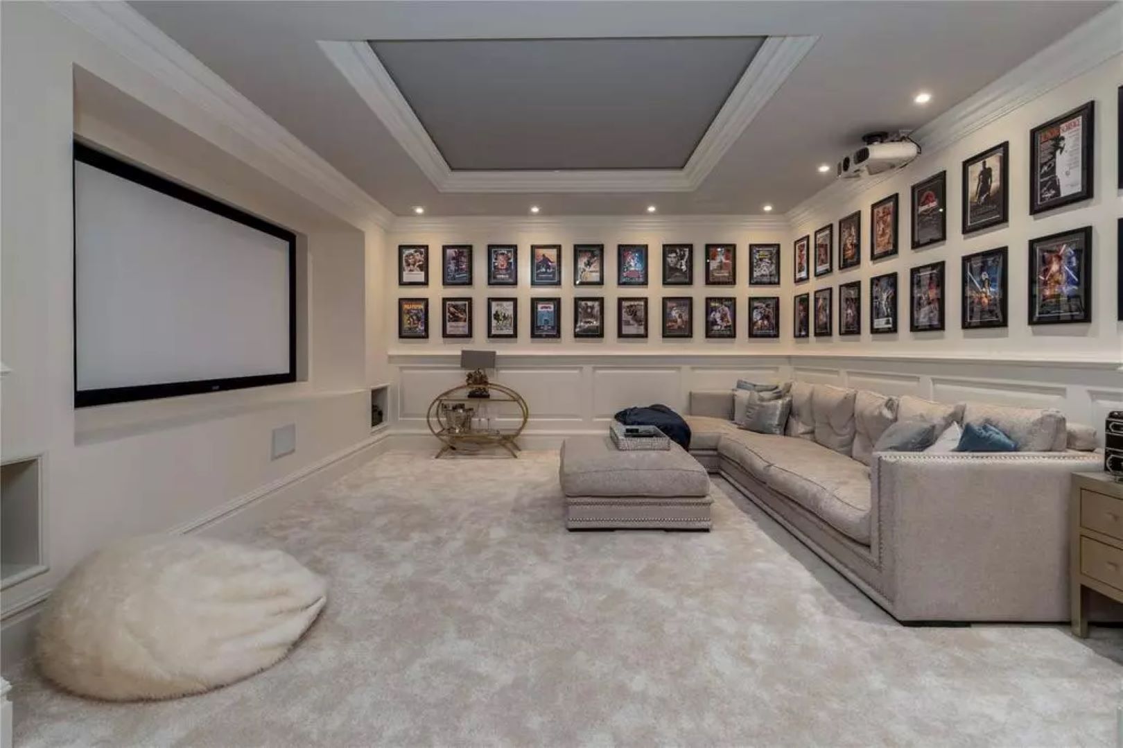Cinema room with beige sofa and framed movie posters