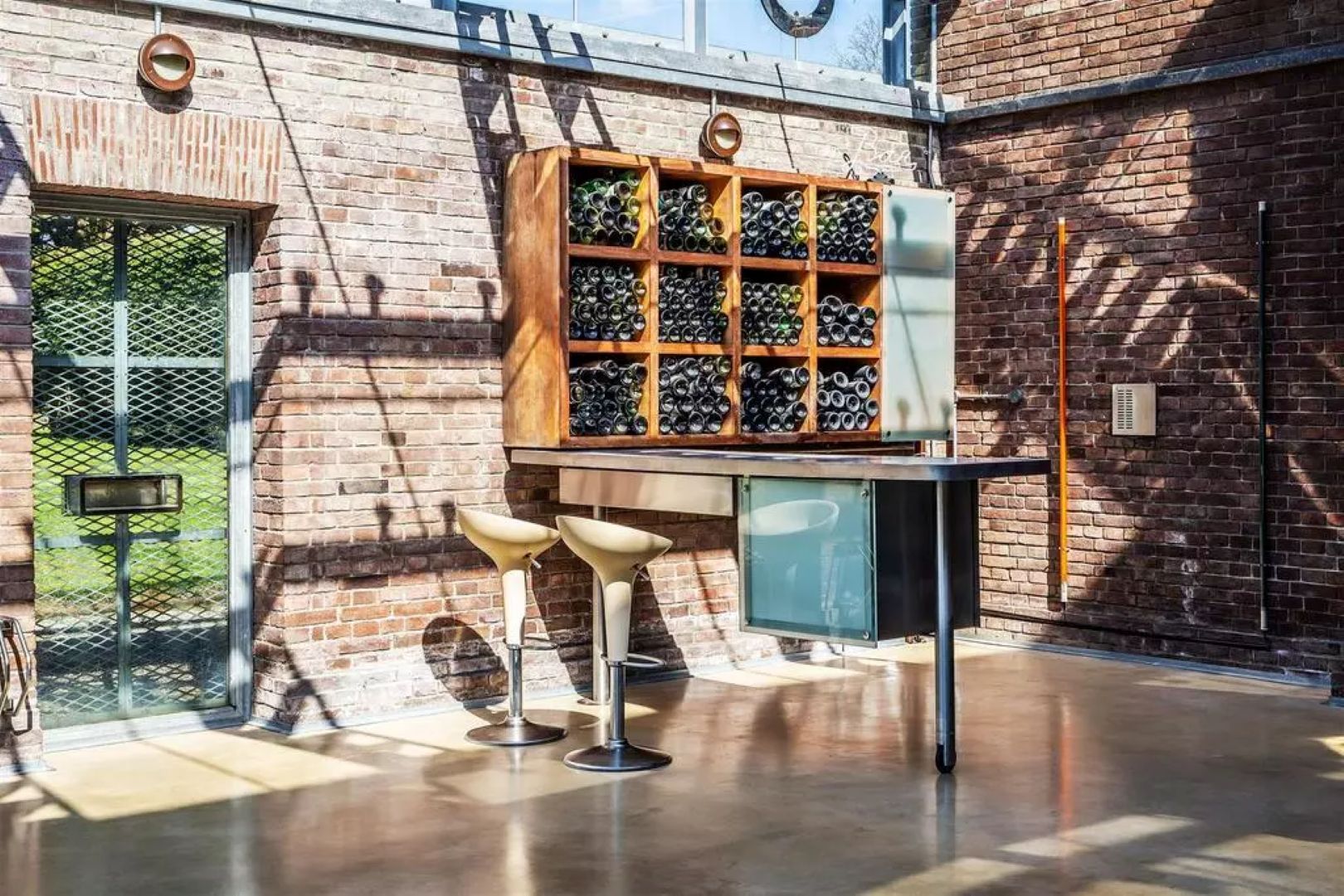 Industrial style bar with brick walls, glass ceiling and open pipe work