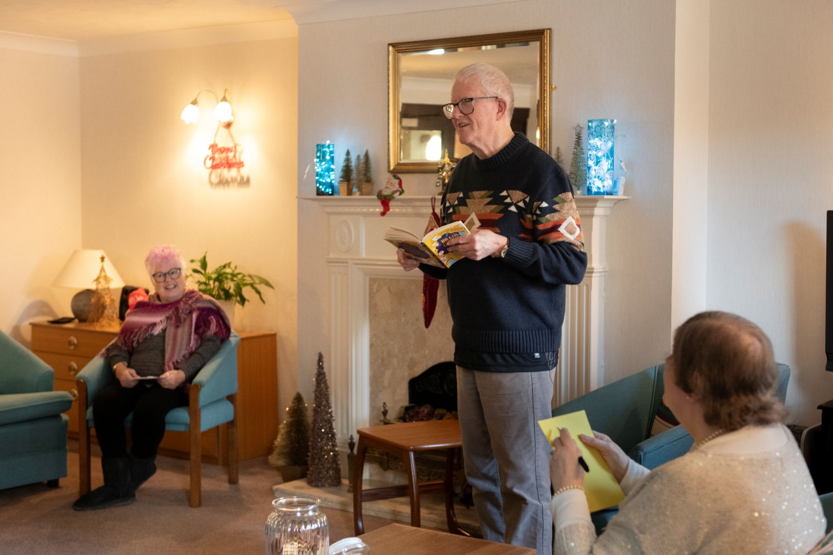 A white man stands as part of a book club