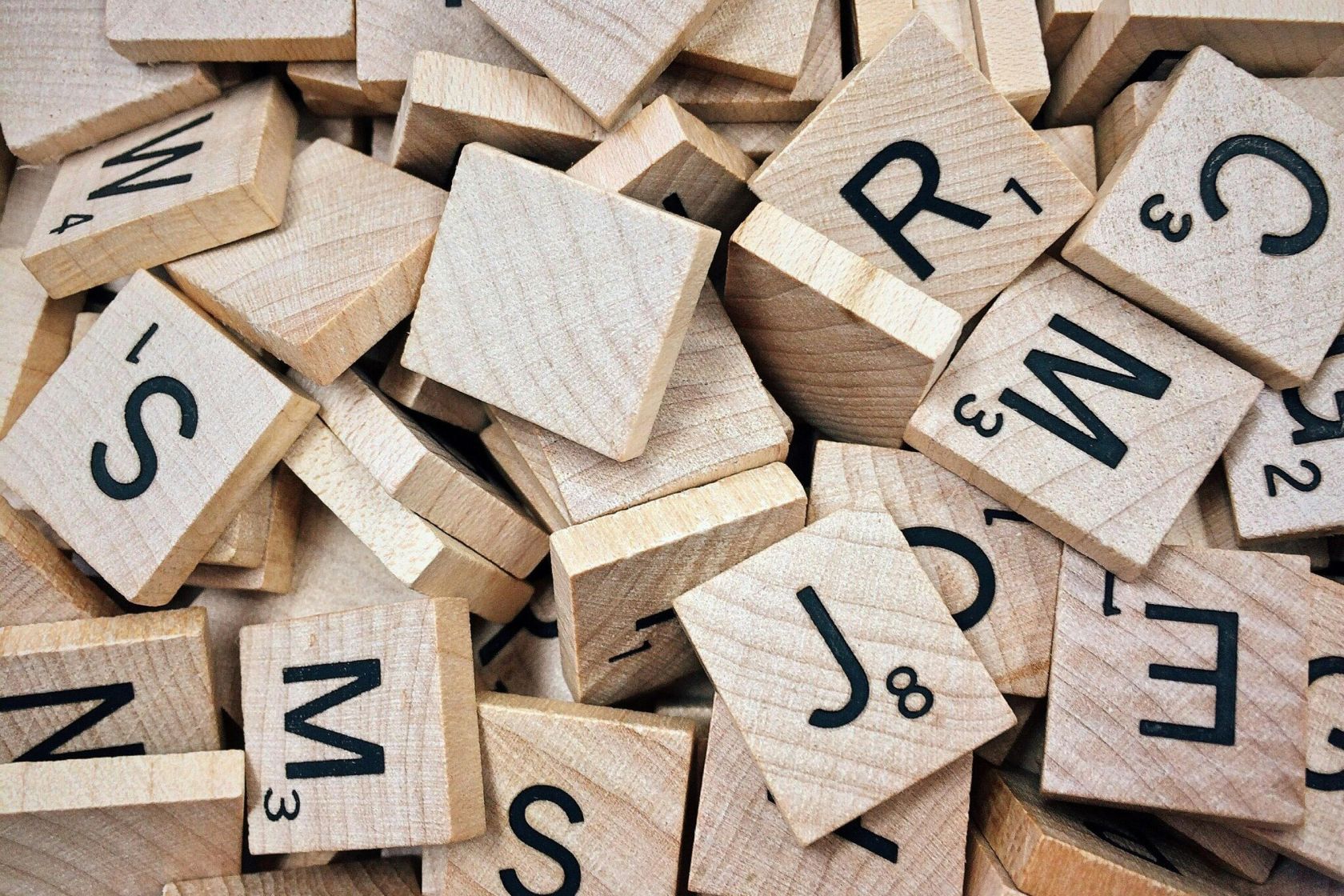 Square, wooden tiles with letters on, similar to Scrabble tiles.