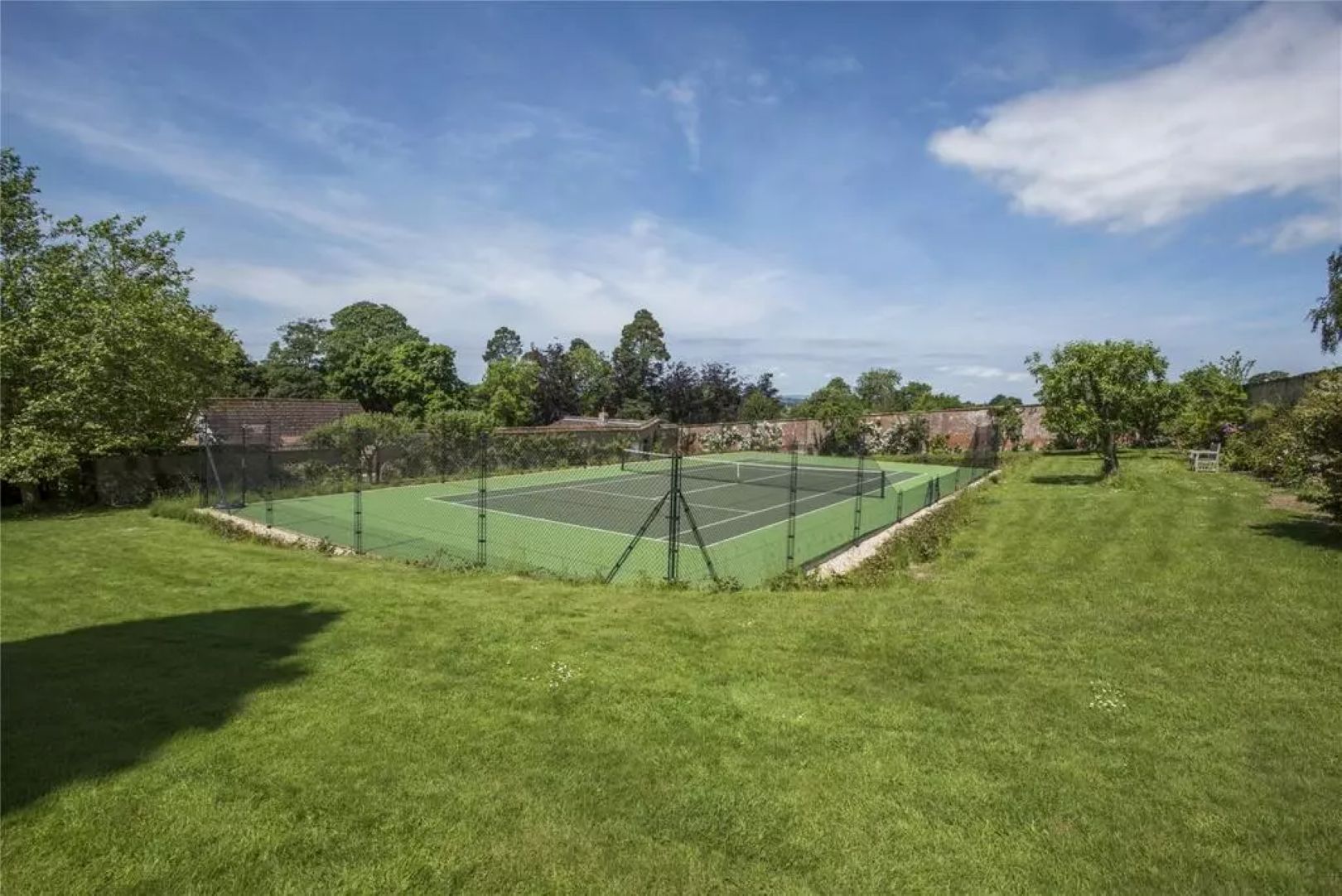 A tennis match sitting within a walled garden