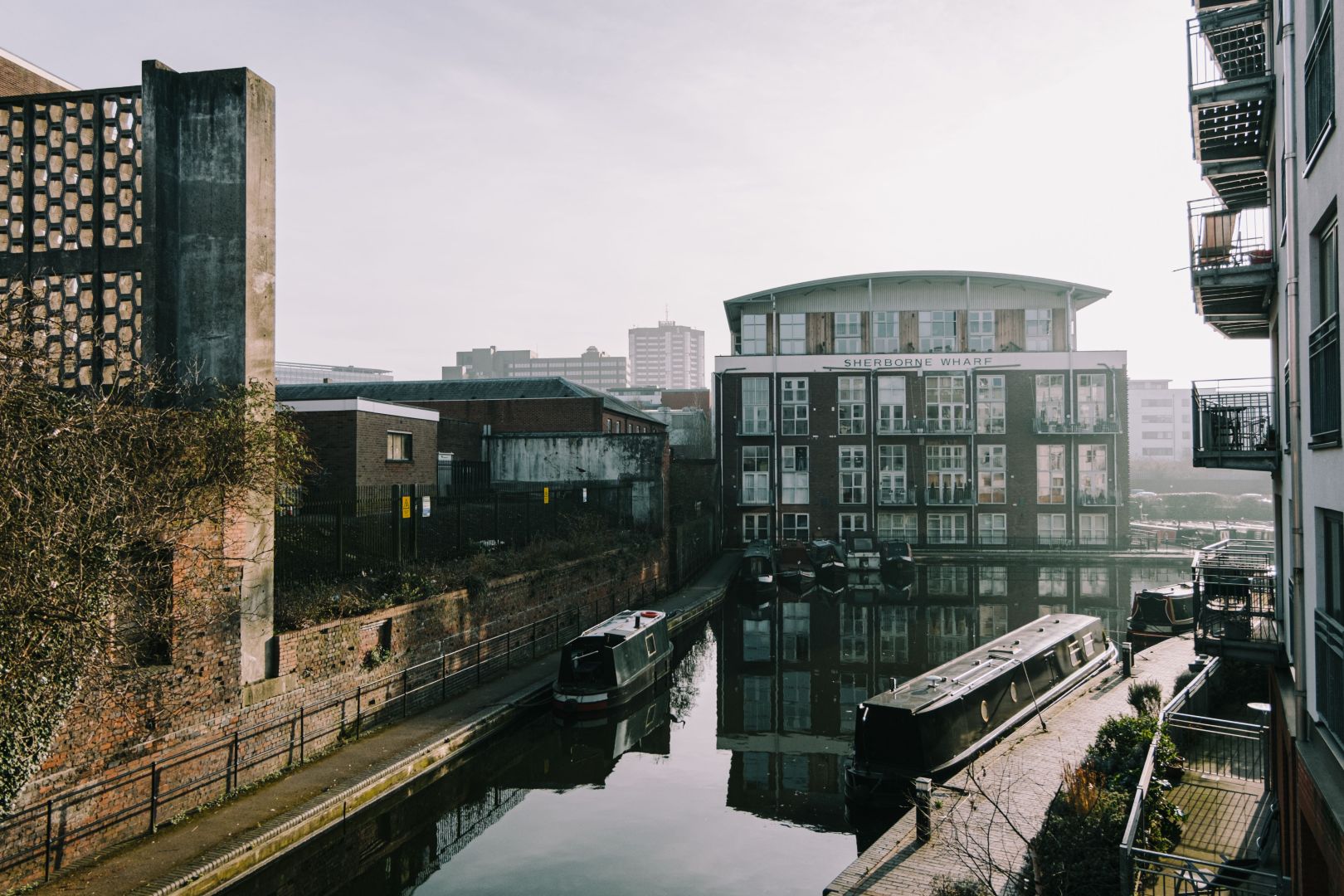 An image of a canal in Birmingham, surrounded by buildings